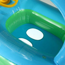 Close-up of the blue and green inflatable baby float chamber showing the sturdy seat build used for safe pool play.