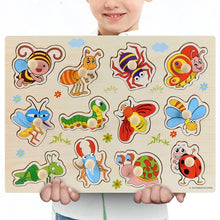 Child holding a Montessori wooden insect illustration puzzle with a simple design for early learning.
