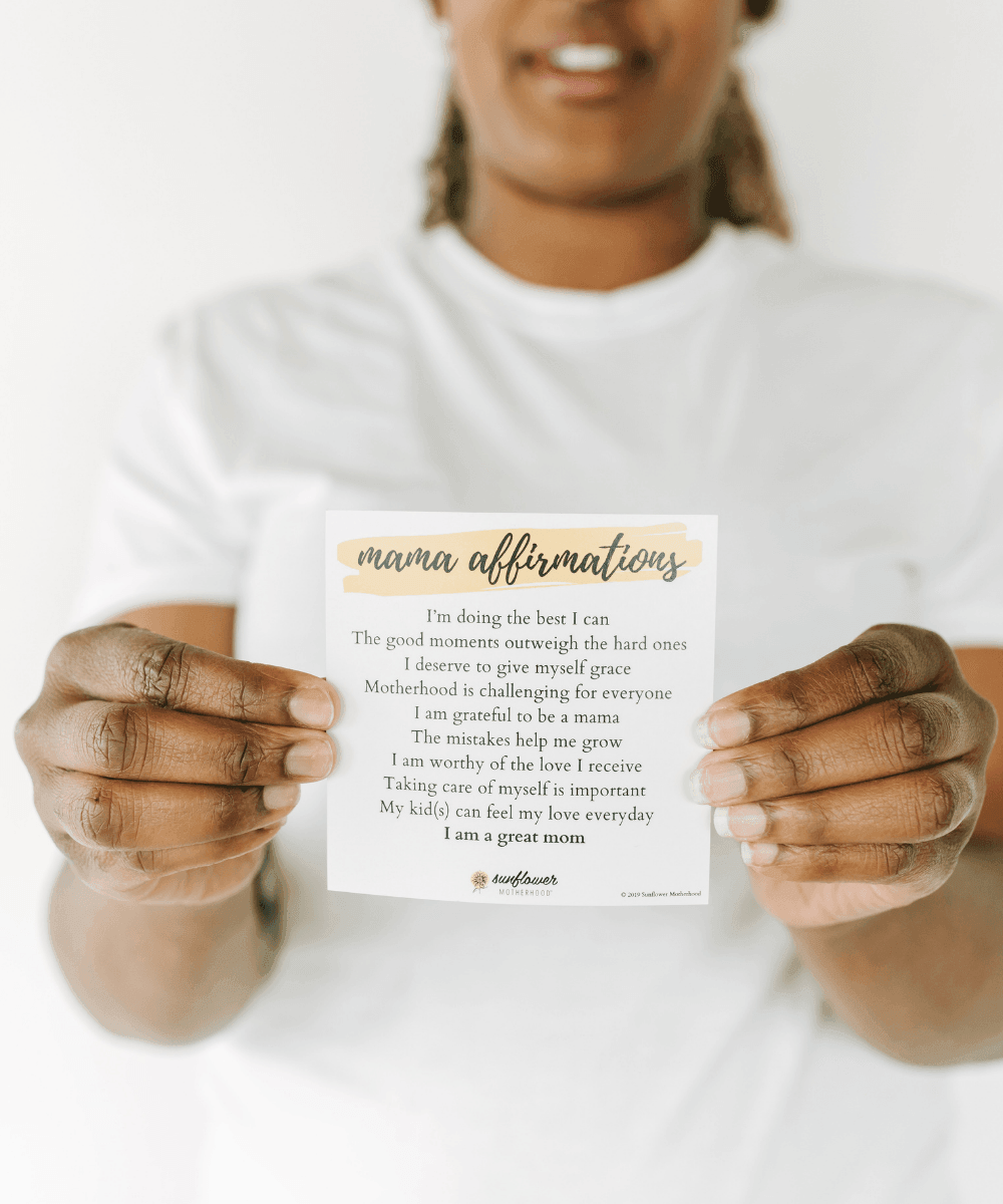 Person holding a card with 'mama affirmations' text