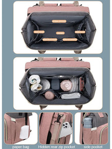 Multifunction folding mommy bag with baby bed opened to show interior storage compartments.