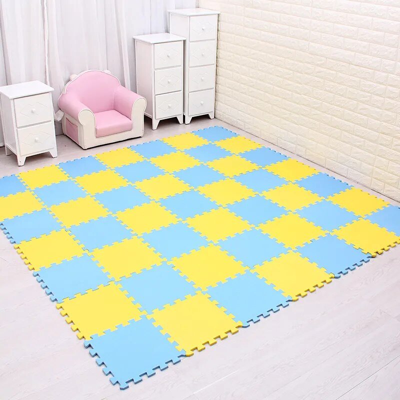 Colorful foam puzzle mat in a room with white furniture and pink chair.