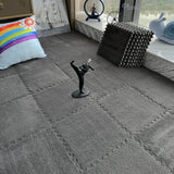 Gray carpet with a decorative figure on a textured surface