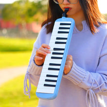 Person playing the blue IRIN Melodica Keyboard outdoors for kids music learning and practice.