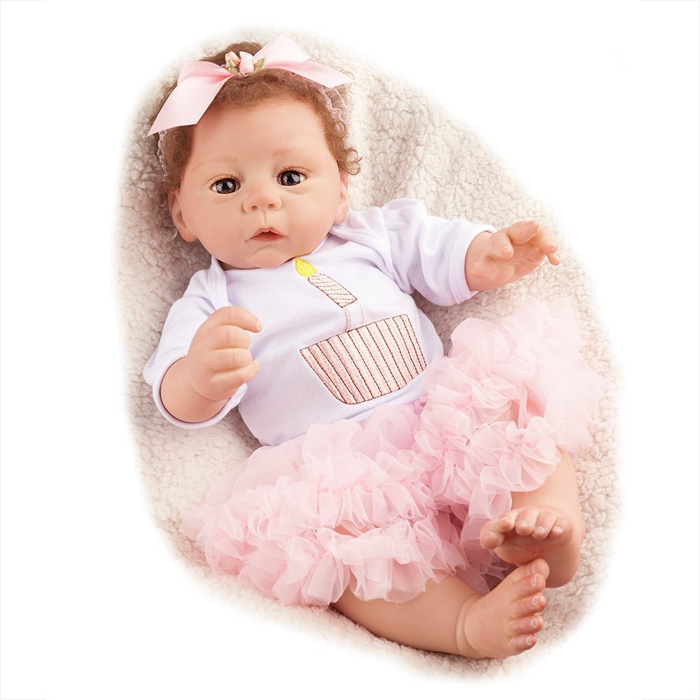 Kaliyah 21 Inch Reborn Baby Doll wearing a white tutu outfit with bow for gifting.