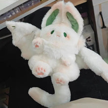 Kawaii Bat Manta plush toy laid flat on a dark surface to show its soft stuffed pillow shape for bedroom decor.