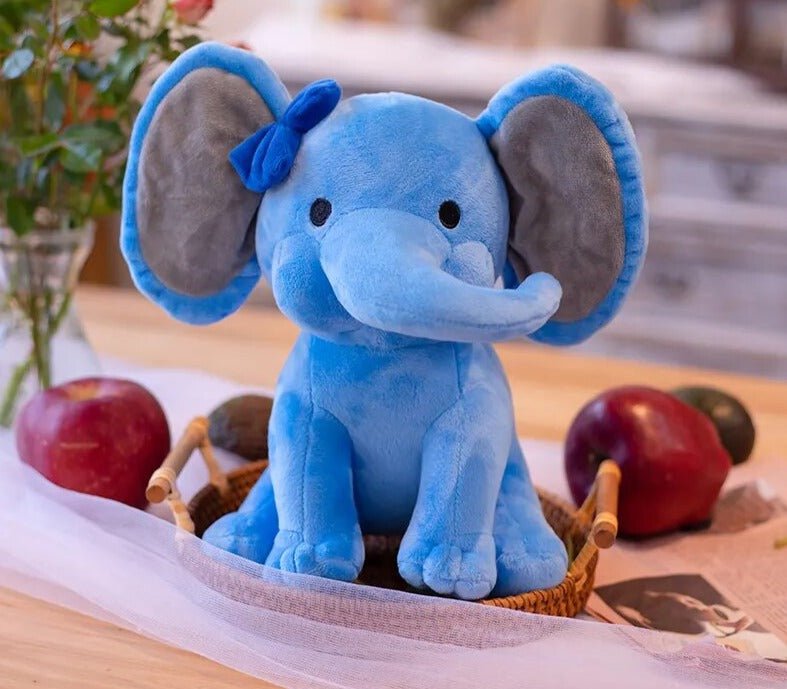 Kawaii Elephant plush toy in blue with a bow styled beside apples for playful stuffed animal decor.