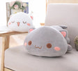 Plush cat-shaped pillow on a chair 