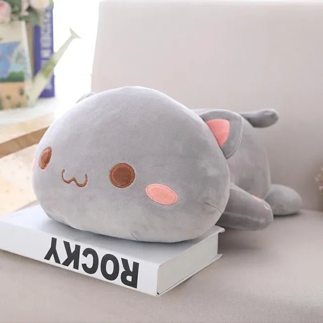 Gray plush cat toy on a book.