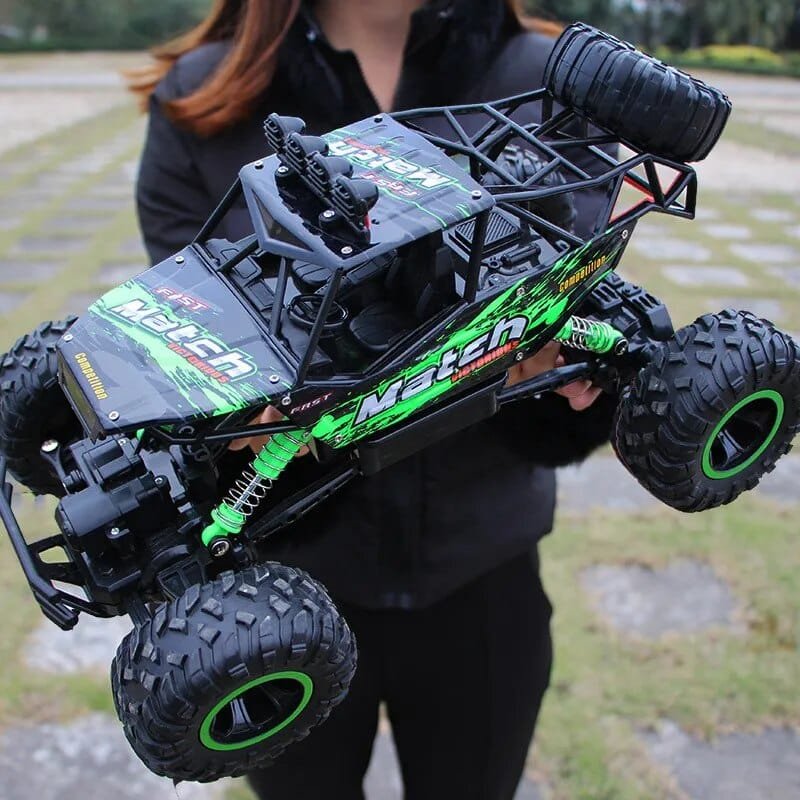 Large 37cm RC monster truck held outdoors to show its scale, a 4WD toy for park racing and dirt track play.