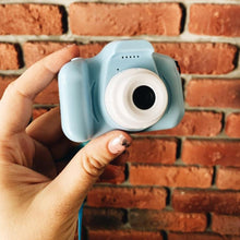 Waterproof Kids Cartoon Camera held in hand showing its compact size for easy outdoor photography by children.