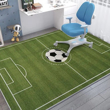 Children's room with a green football field rug and blue chair.