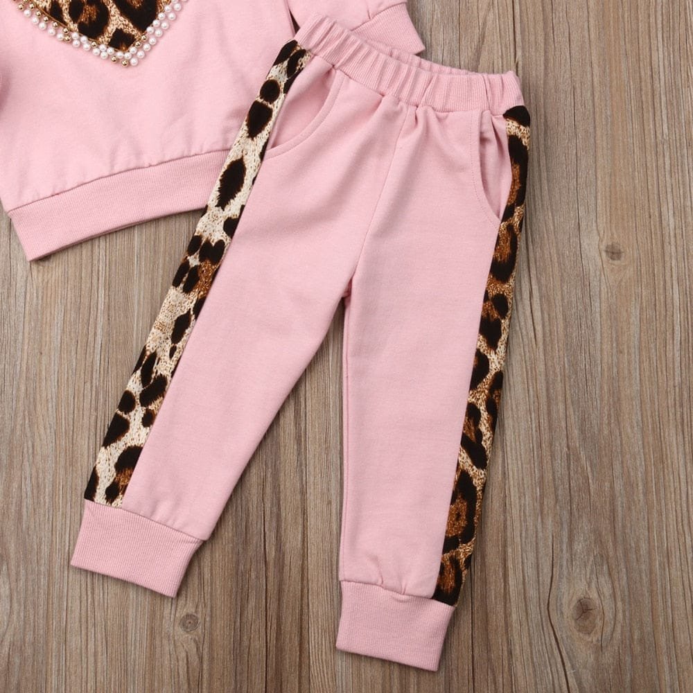 Girls pink sweatpants with leopard print side panels for comfortable play and school days.