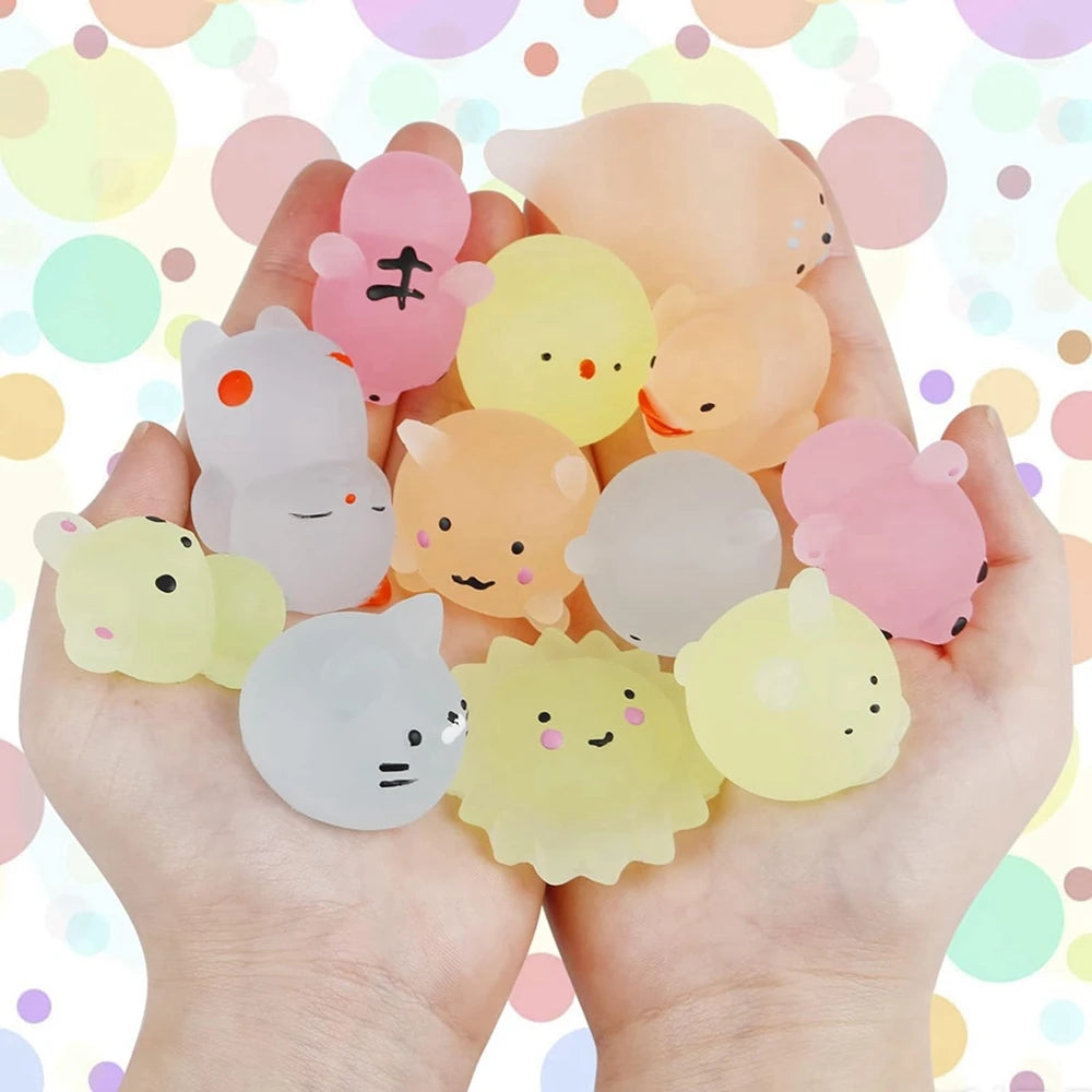 Hand holding various small animal figurines 