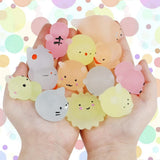 Hand holding various small animal figurines 
