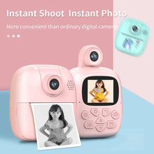 Pink kids instant print camera with a printed photo of a girl and a screen showing her picture