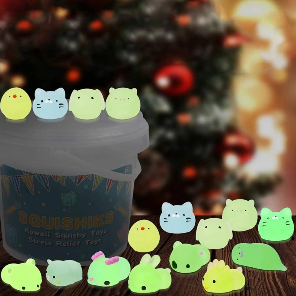 Glowing squishy toys in front of a blurred Christmas tree