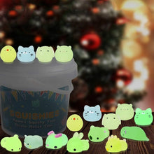 Glowing squishy toys in front of a blurred Christmas tree