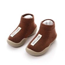 Pair of brown children's socks with 'SELF-CARE' label