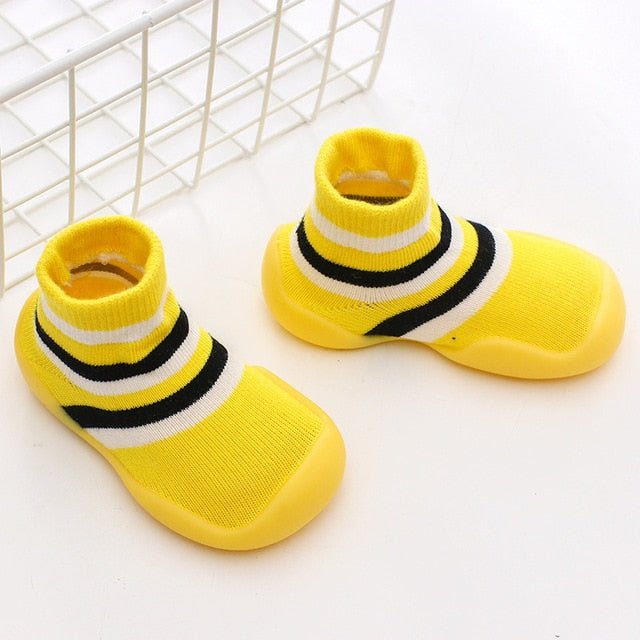 Yellow socks with black and white stripes on a light background