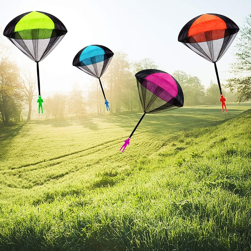 Colorful paragliding parachutes on a grassy field