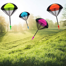 Colorful paragliding parachutes on a grassy field