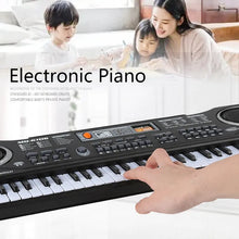 Kids piano keyboard played by hand with family nearby, a beginners music gift for shared playtime.