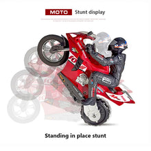 Red toy motorcycle with rider performing a stunt.