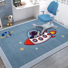Children's room with a blue rug featuring a space-themed design, a blue chair, and toys.