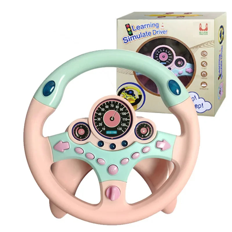 Mint and pink steering wheel toy with a speedometer dial and its box behind