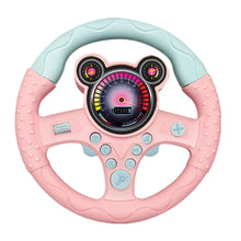 Pink steering wheel toy with a mint top and round ear shapes on the dash