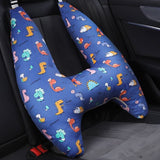 Blue U-shaped car pillow with dinosaur pattern on a car seat