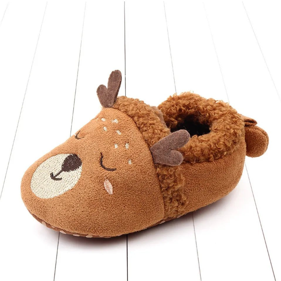 Angled display of cream Knit Baby Slippers, an easy slip-on pair for nappy changes and quick outings.