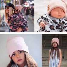 Knitted baby beanie worn by a baby and toddler for everyday winter dressing, pram walks, and park visits.