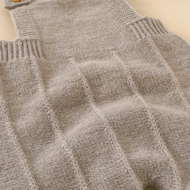 Close-up of the soft textured knit on the baby romper for warm, breathable comfort during cooler days.