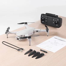 L900 Pro SE Drone in white shown on a wooden surface for size reference before flying.