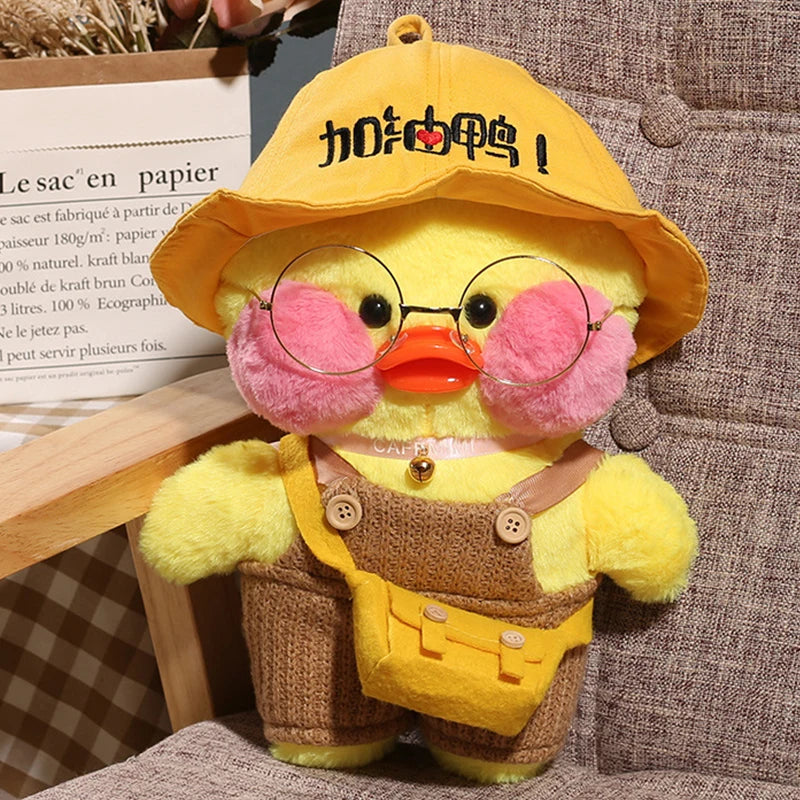 Yellow cafe duck plush toy wearing glasses and a hat for cosy everyday cuddles and desk company.