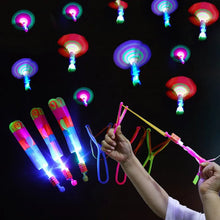 LED Light Arrow Toy slingshot held by hand for outdoor nighttime party fun.