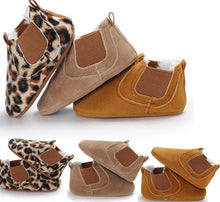 Pair of baby shoes with leopard print and brown suede.