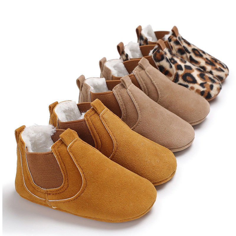 Row of baby shoes in various colors 