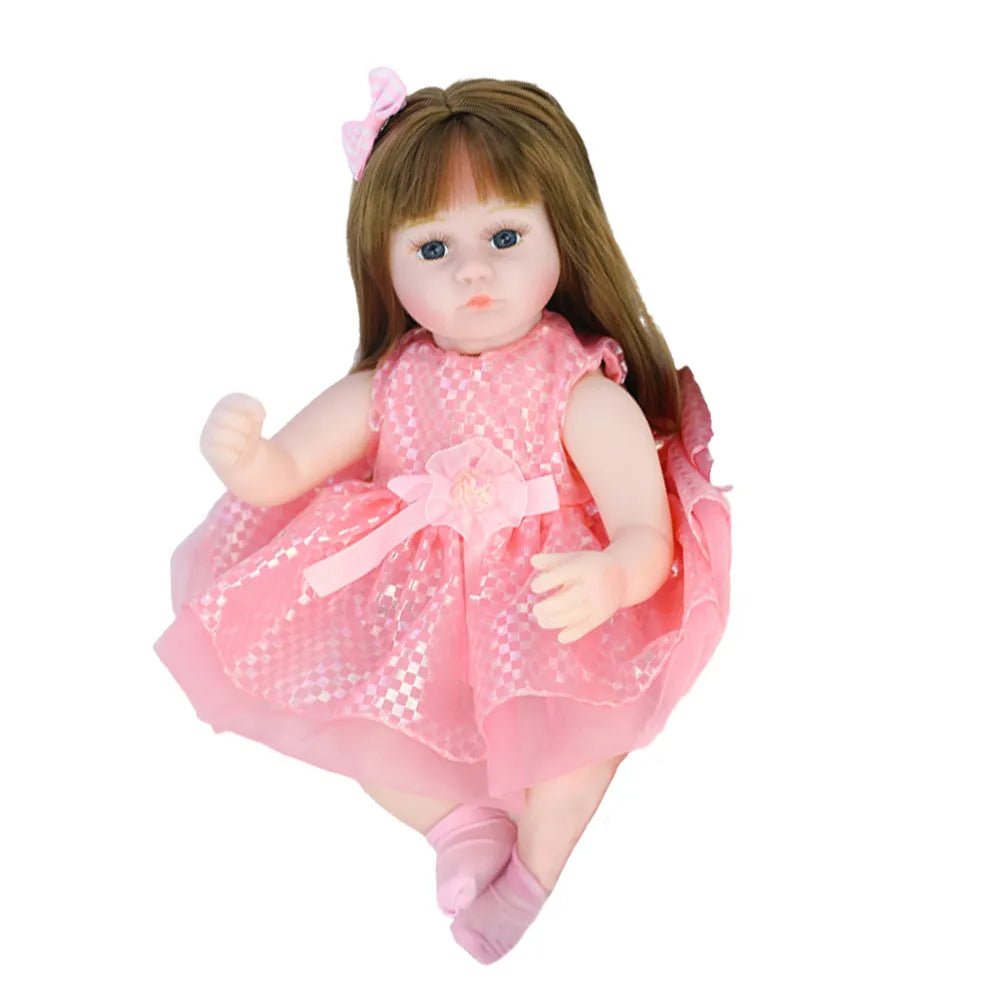Doll with long brown hair wearing a pink dress.
