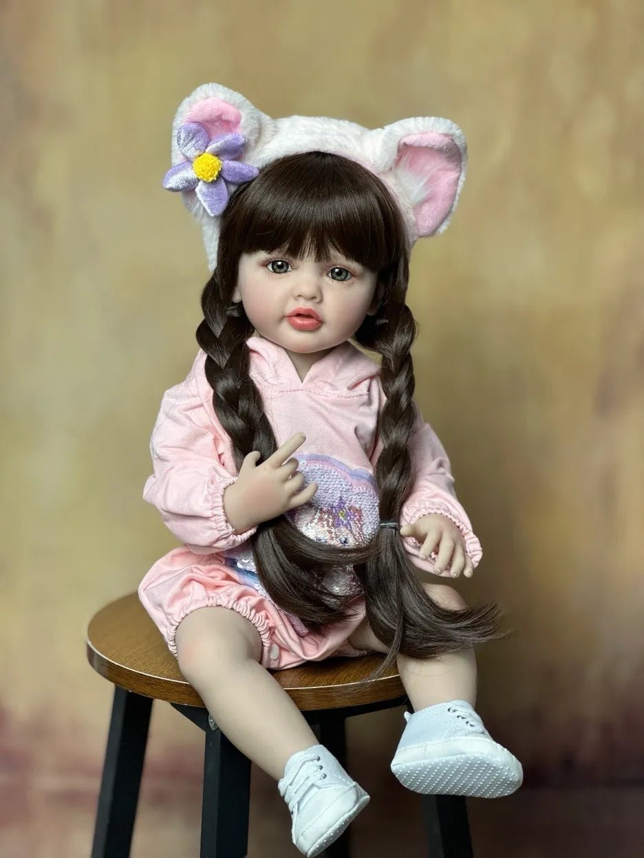 Lifelike silicone Reborn Newborn Girl Doll in a cat-ear hood and pink outfit for playful dress-up and toddler pretend play.