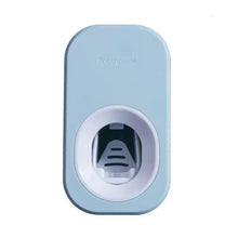 Light blue automatic toothpaste dispenser for hands-free squeezing and neat bathroom storage.