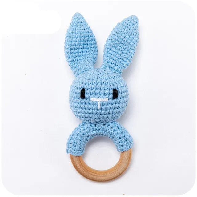 Light blue bunny crochet baby rattle and teether ring, a handmade wooden toy for baby boys during teething.