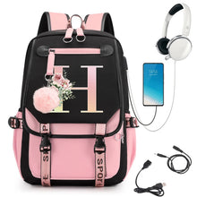 Pink and black backpack with floral design, smartphone, headphones, and USB cable.
