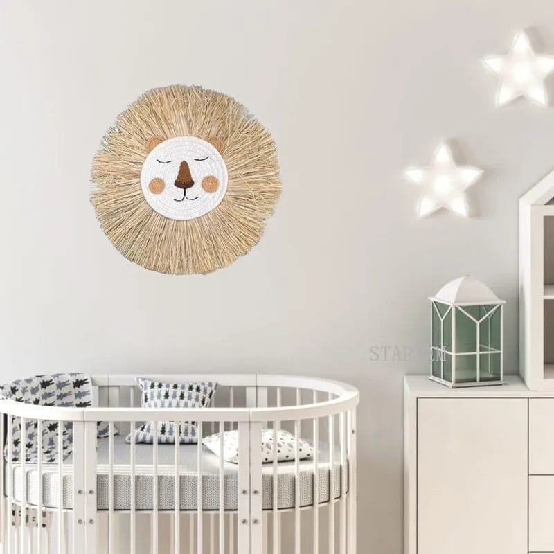 Lion wall hanging styled above a nursery crib for calming boho decoration in baby and toddler rooms.