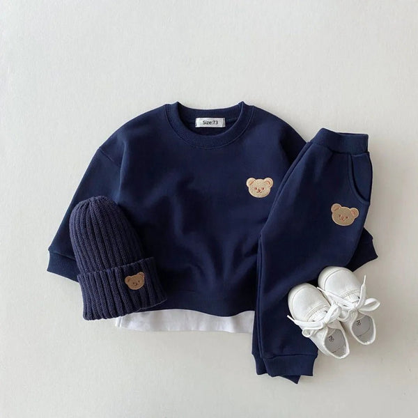 Navy blue children's outfit with bear ears, including a sweater, pants, hat, and shoes.