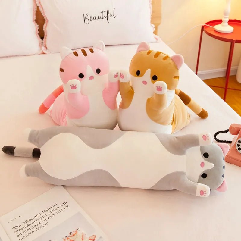 Long Cat Body Pillow Plush Toy on a bed, used for napping and cuddles during downtime.