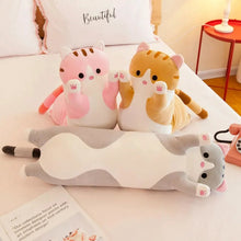 Long Cat Body Pillow Plush Toy on a bed, used for napping and cuddles during downtime.