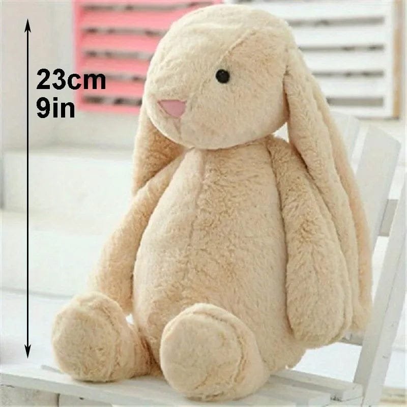 Beige plush bunny toy with measurement label.