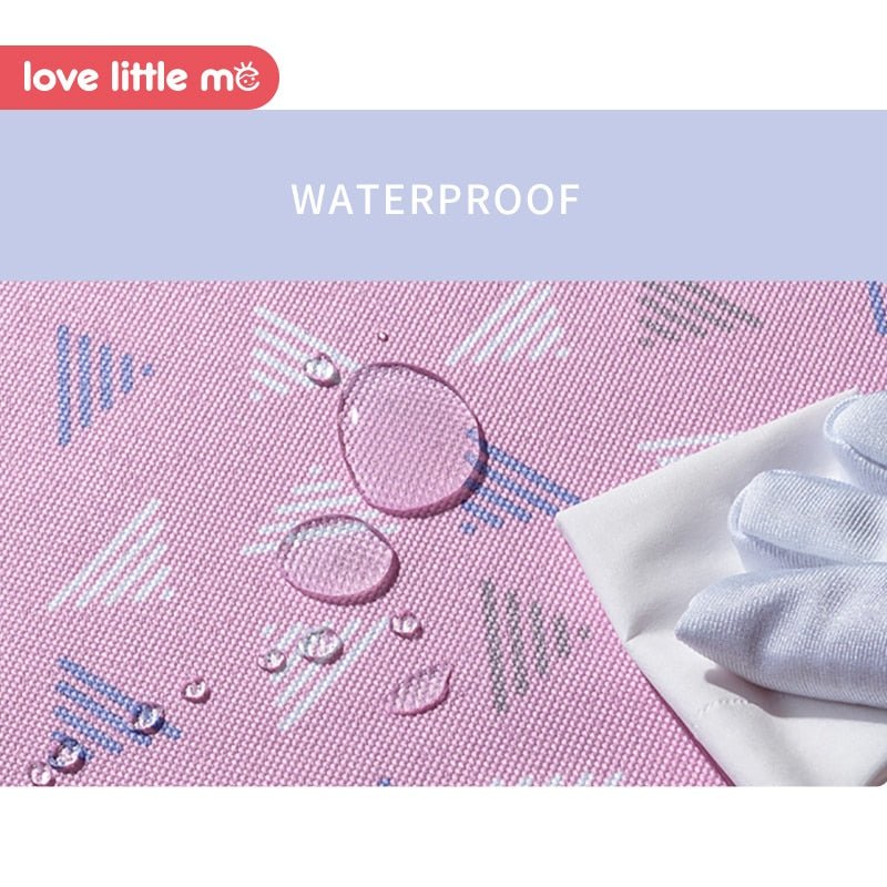 Love Little Me Portable Baby Diaper Bag pink waterproof fabric detail for easy cleaning.